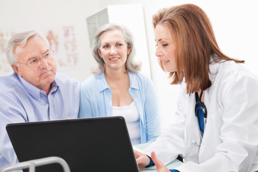 Man and woman talking with a doctor